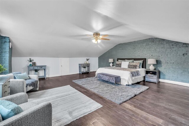 bedroom with dark hardwood / wood-style flooring, ceiling fan, lofted ceiling, and brick wall