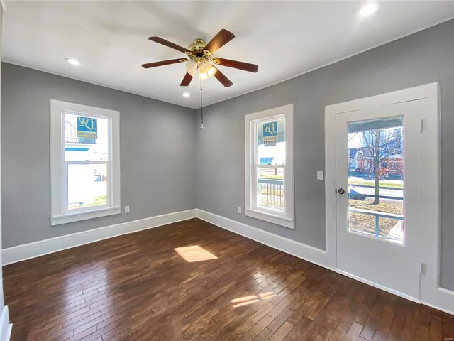 unfurnished room with dark hardwood / wood-style floors and ceiling fan