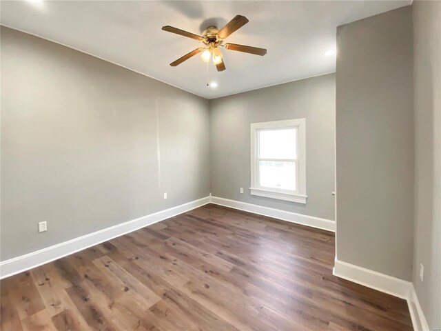 unfurnished room featuring ceiling fan and dark wood-type flooring