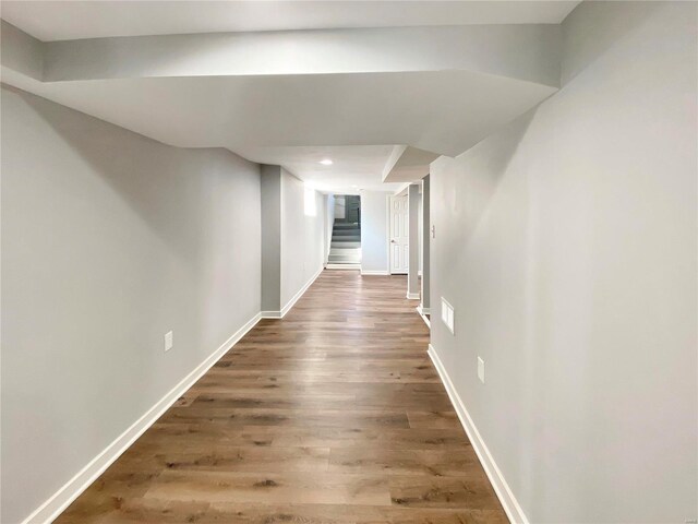 corridor with dark hardwood / wood-style flooring