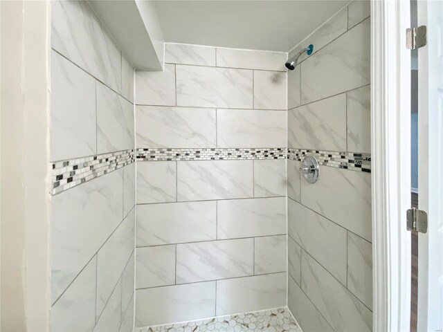 bathroom with tiled shower