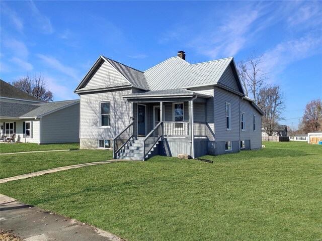 view of front of home featuring covered porch and a front yard