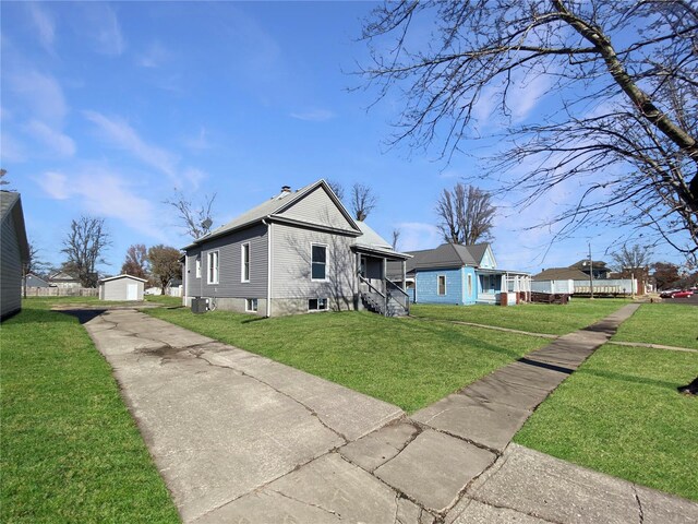 exterior space featuring an outbuilding, a garage, and a lawn