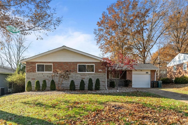 ranch-style home featuring a front yard, central AC, and a garage