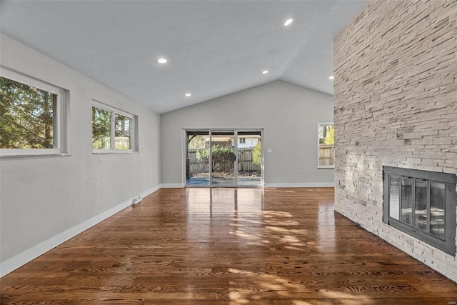 unfurnished living room with dark hardwood / wood-style flooring, a fireplace, and vaulted ceiling