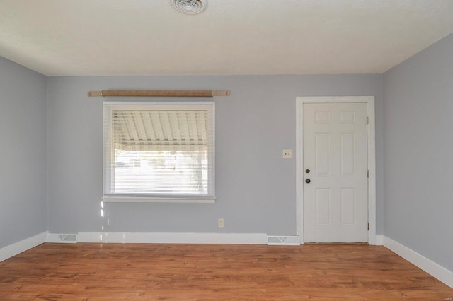 empty room with hardwood / wood-style floors