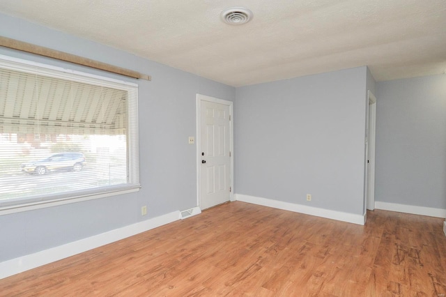 empty room featuring hardwood / wood-style floors and a textured ceiling