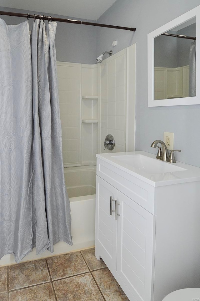 bathroom featuring tile patterned flooring, vanity, and shower / bath combo