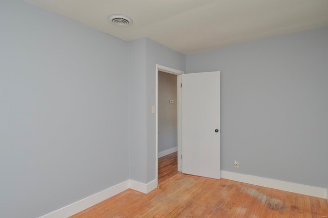 unfurnished room with light wood-type flooring