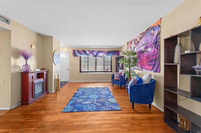 sitting room with wood-type flooring