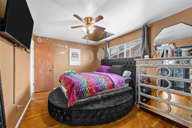 bedroom with wood-type flooring and ceiling fan