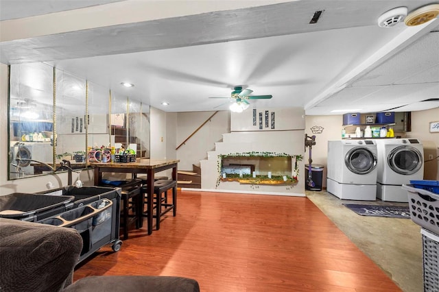 interior space with ceiling fan, washing machine and dryer, and concrete flooring