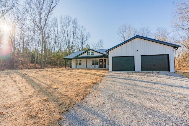 single story home featuring a porch and a garage