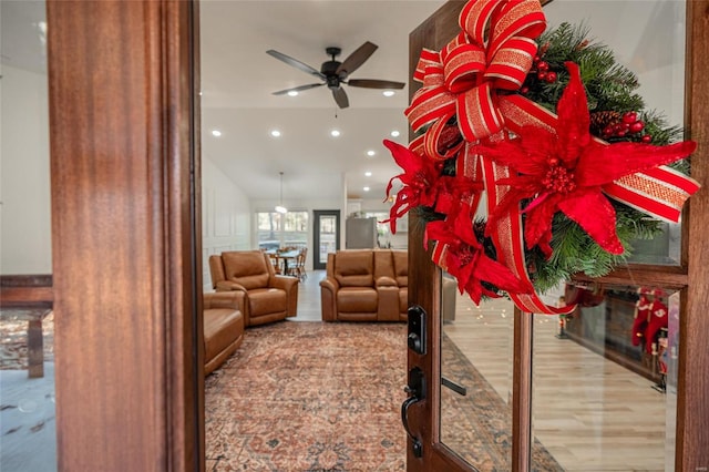 living room with ceiling fan and light wood-type flooring