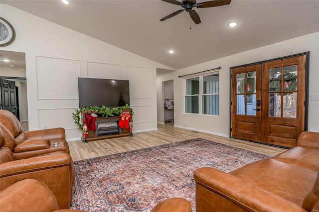 living room with ceiling fan, french doors, hardwood / wood-style floors, and lofted ceiling