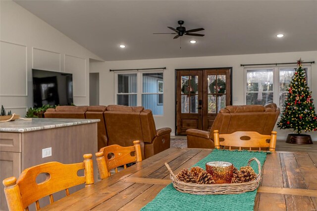 dining area with french doors, light wood-type flooring, vaulted ceiling, and ceiling fan