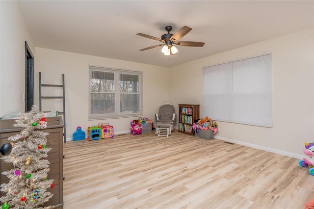 rec room with ceiling fan and light hardwood / wood-style flooring