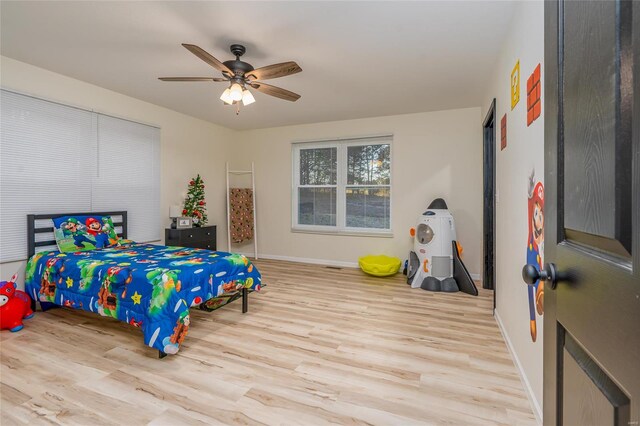 bedroom with ceiling fan and light wood-type flooring