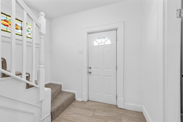 entrance foyer with baseboards and stairs