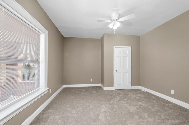 unfurnished room with light carpet, ceiling fan, and baseboards