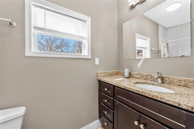 bathroom with baseboards, a shower with shower curtain, vanity, and toilet