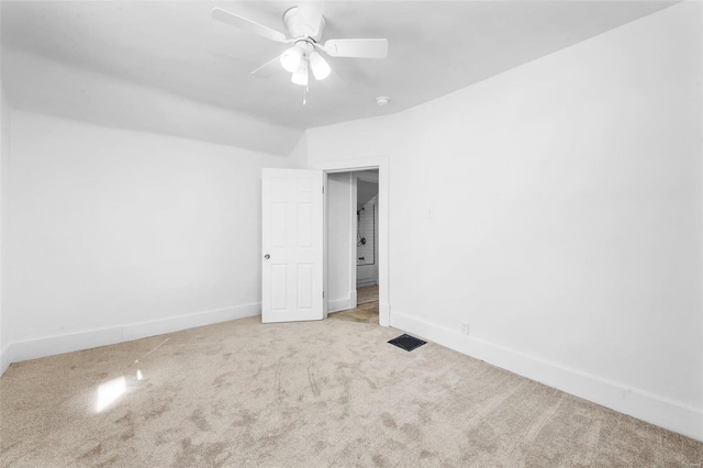 unfurnished bedroom with light carpet, visible vents, baseboards, and ceiling fan