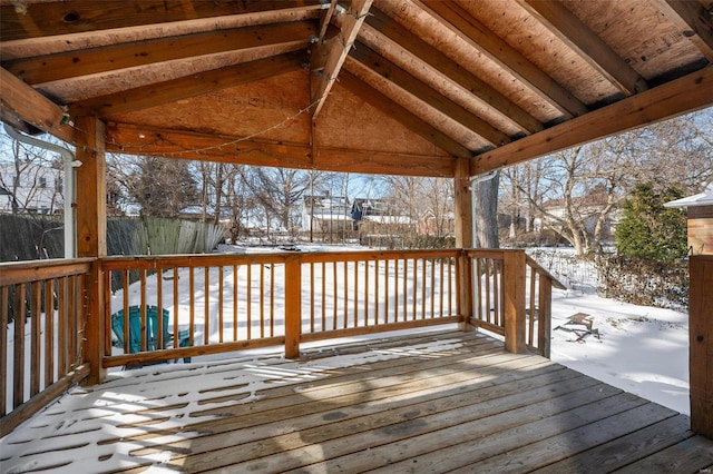 snow covered deck with fence