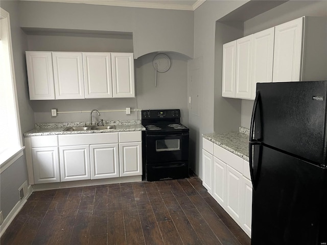 kitchen with white cabinets, sink, dark wood-type flooring, and black appliances