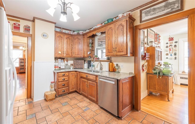 kitchen with dishwasher, radiator, sink, a notable chandelier, and light hardwood / wood-style floors