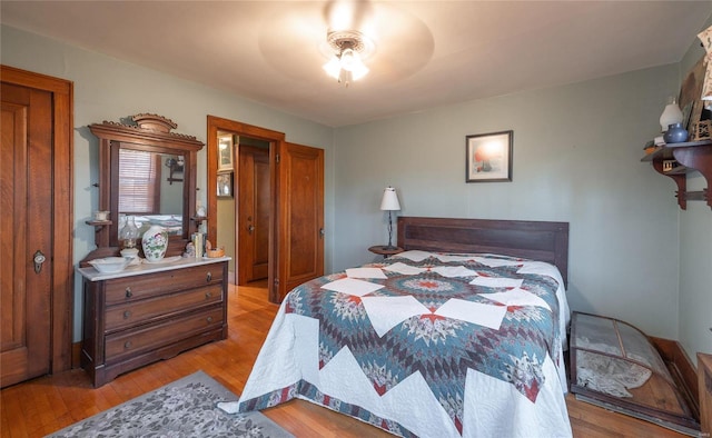 bedroom with light hardwood / wood-style floors and ceiling fan