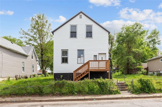 back of house with a deck