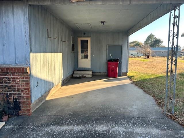 view of exterior entry with a carport