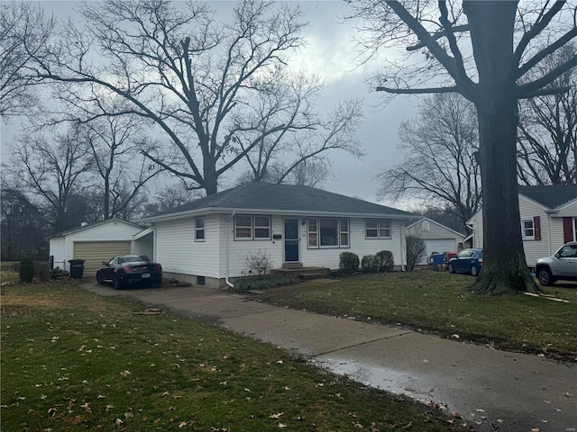 view of front facade with a front yard, an outdoor structure, and a garage