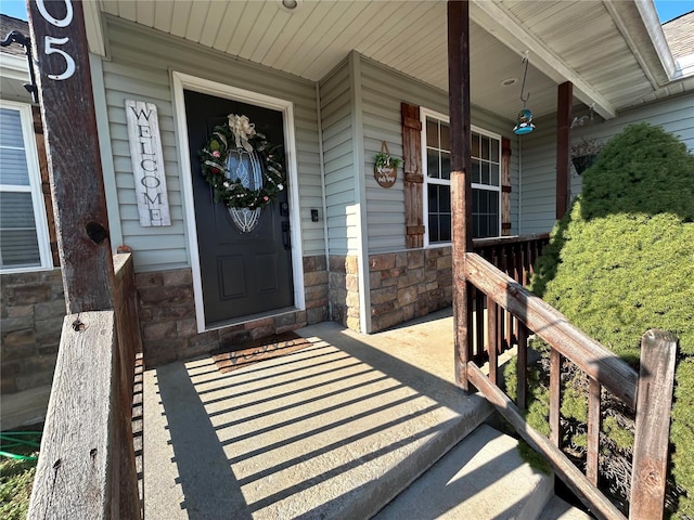 view of exterior entry featuring a porch