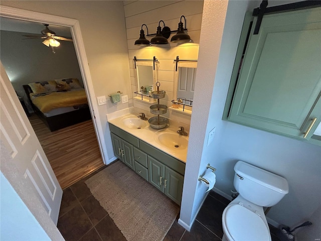 bathroom featuring hardwood / wood-style floors, vanity, toilet, and ceiling fan