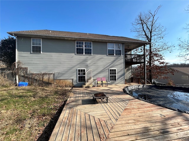 rear view of house with a balcony and a deck