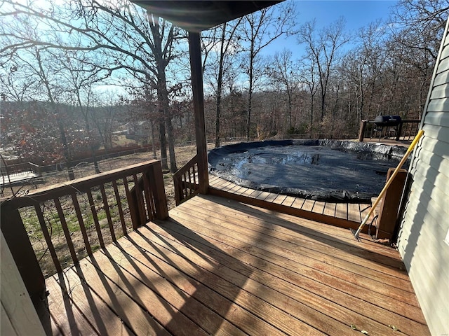 wooden terrace with a covered pool