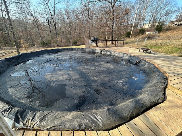 view of pool featuring a hot tub and a deck