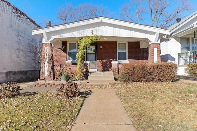 view of front of home with covered porch and a front yard