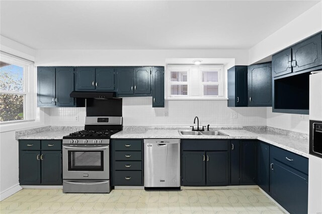 kitchen featuring light stone countertops, sink, and appliances with stainless steel finishes