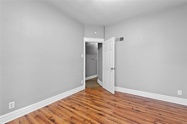 empty room featuring wood-type flooring