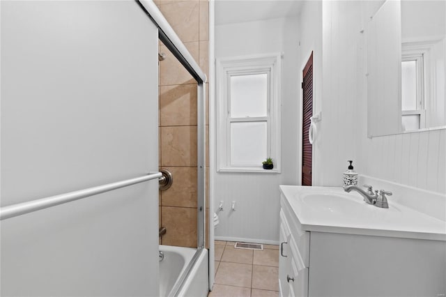 full bathroom featuring toilet, vanity, tile patterned floors, and tiled shower / bath combo