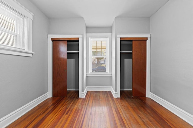 unfurnished bedroom featuring dark hardwood / wood-style floors