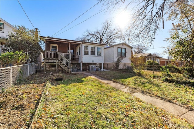 view of front of house with a front yard and cooling unit