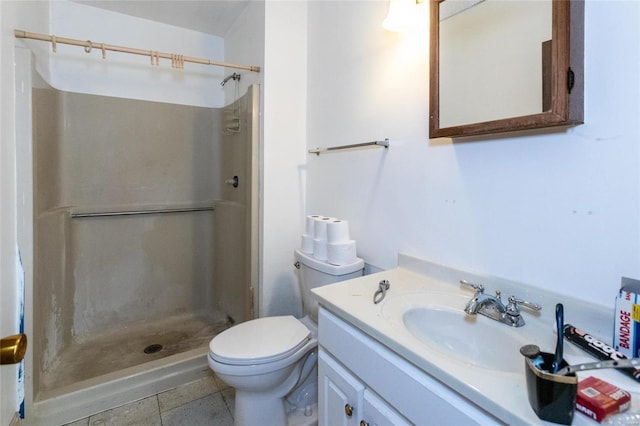 bathroom featuring toilet, vanity, tile patterned floors, and walk in shower