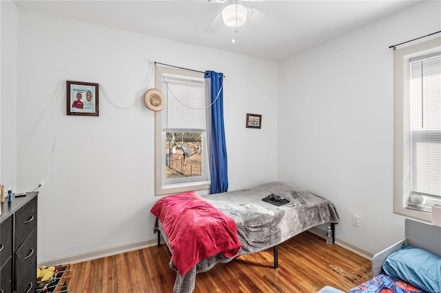 bedroom with ceiling fan and wood-type flooring