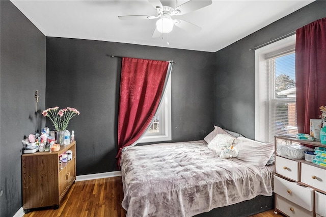 bedroom with ceiling fan and dark wood-type flooring