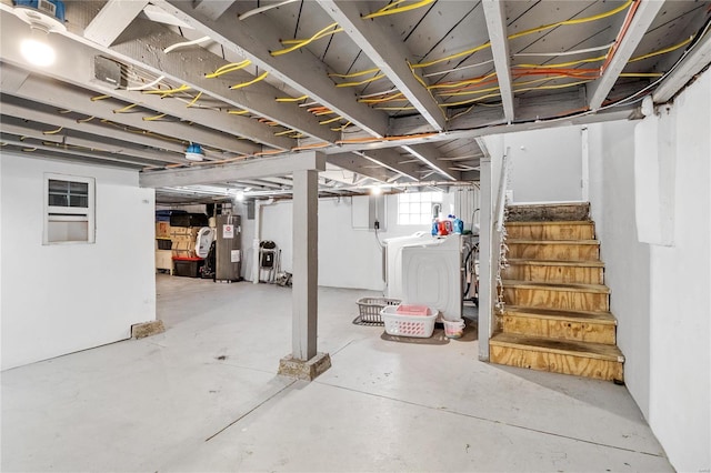 basement featuring independent washer and dryer and water heater