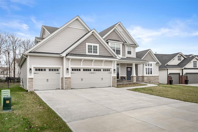 craftsman house with a garage, a porch, and a front yard