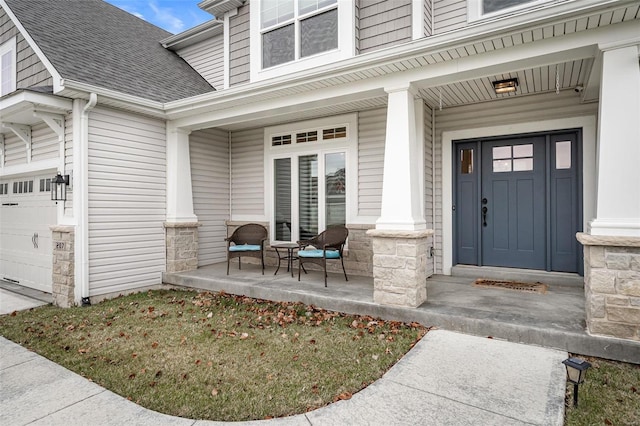 property entrance featuring a garage and a porch